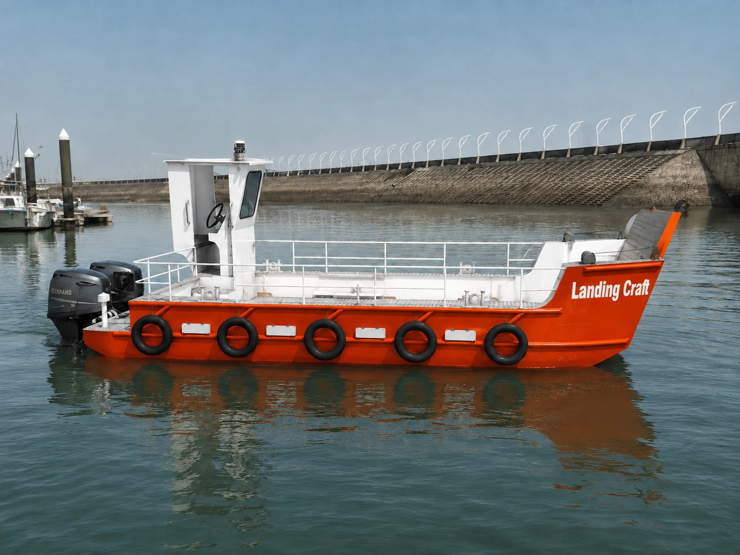 Red and white 8.8 metre Desail landing craft on sheltered water